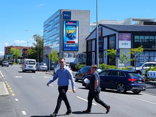 Jack Reeves Walking in front of St Asaph Street billboard site without a care in the world